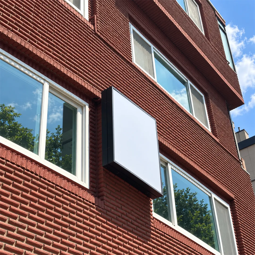 Red brick building wall with a square sign box and windows